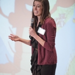 Woman presenting to the audience, her hand gesturing as she speaks